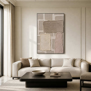 Neutral textured wall art in a black frame above a modern living room sofa.