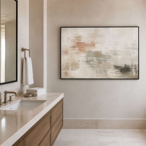 Calm neutral wall art in a black frame near a bathroom vanity.