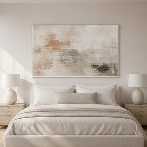 Soft neutral textured canvas in a white frame above a bedroom bed.