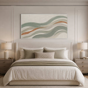 Sage and ivory coastal wall art styled above a neutral bed.