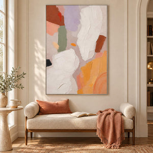 Abstract painting with ivory, lilac, sage, terracotta, and ochre forms in a silver frame in a reading room.