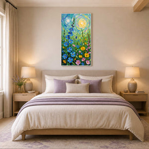 White-framed tall flower painting above a cream bed with lavender pillows and throw.