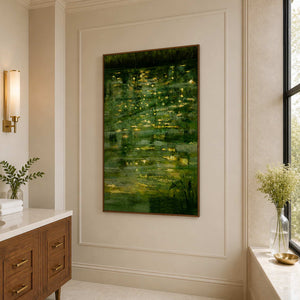 Wood framed green landscape beside a bathroom vanity and a tall bright window.