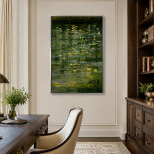 Silver framed waterside landscape behind a cream desk chair in a bright study.