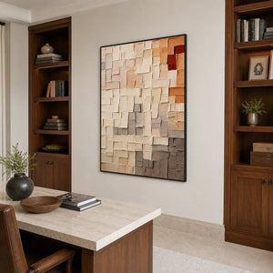 Black-framed textured abstract wall art above a stone-topped desk between wooden shelves.