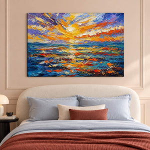 Textured seascape painting with a gold and orange sunset over blue water without an outer frame in a bedroom.