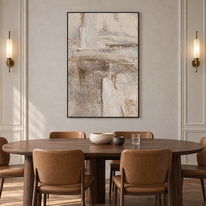 Cream and gray abstract over an oval dining table with brown chairs between wall sconces.