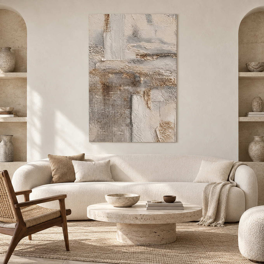 Pale textured abstract above a cream sofa between recessed display shelves.