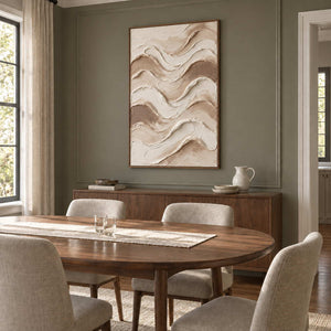 Tenderness in a wood frame above a sideboard behind an oval dining table with neutral upholstered chairs.