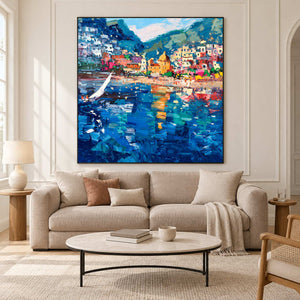 Colorful bay painting above a cream sofa and oval coffee table.