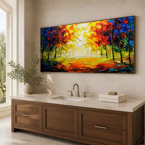 Wood-framed golden woodland painting above a stone vanity in a bright bathroom.