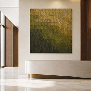 Gold and green abstract relief painting in a sophisticated commercial lobby.