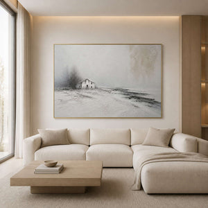 Textured winter landscape wall art in a serene living room with a gold frame.