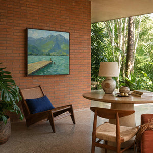 Textured mountain lake canvas in a warm modern sunroom.