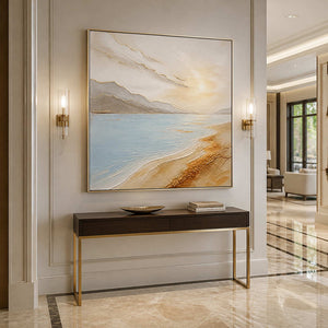 Luminous coastal landscape displayed in an elegant residential entryway.