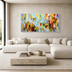 Panoramic colorful textured wall art displayed above a bright white living room sofa.