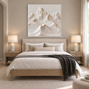 The Mountains Stand Watch in a white frame above a wood bed with white linen and a dark gray throw.