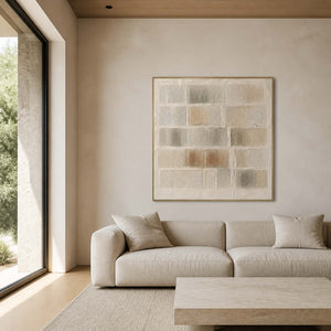 Textured neutral wall art displayed in a warm ivory stone living room.