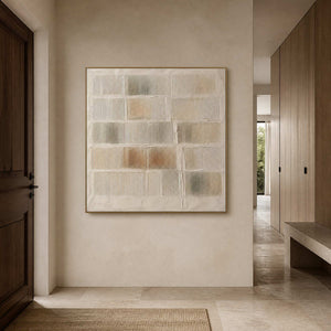 Square minimalist wall art displayed in a warm stone residential entryway.