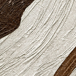 Close-up of diagonal raised ivory grooves bordered by dark brown textured paint.