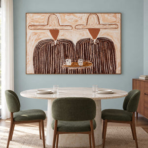 Shared-table artwork behind a round dining table with green chairs.