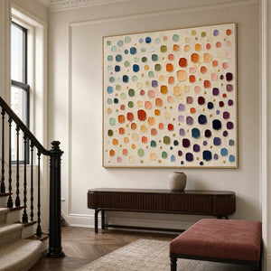 Colorful abstract wall art styled above a refined entryway console.