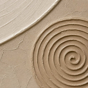 Close-up of sculpted warm stone spiral relief and hand-painted surface texture.