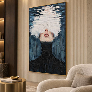High-collar figure artwork on a ribbed beige wall beside a cream armchair.