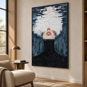 Tall blue-gray portrait beside a cream reading chair and a small lamp near the window.