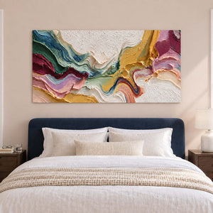 Flowing band artwork over a navy headboard and pale bedding on a blush wall.