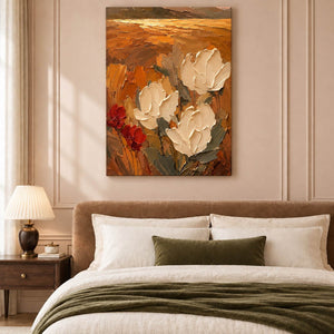 Textured cream flowers painting against an amber and rust background without an outer frame in a bedroom.