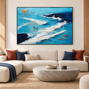 Turquoise coastal painting with three figures among white breaking waves in a black frame in a living room.