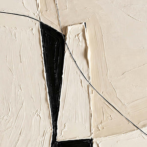 Close view of a thin black curve crossing raised ivory paint and a dark wedge.