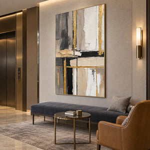 Tall textured abstract above a charcoal bench and small round table in a lounge.