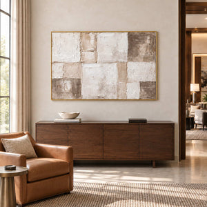 Time in Soft Focus in a gold frame above a wood sideboard beside a brown leather chair in a commercial lounge.