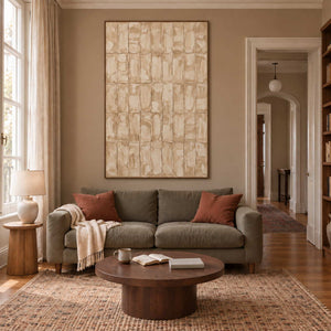 Time in Verse in a brown wood frame above an olive sofa with rust cushions and a round coffee table.