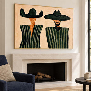 Two-figure artwork over a pale fireplace beside a navy armchair.