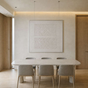 Monochrome relief canvas displayed above an elegant dining table.