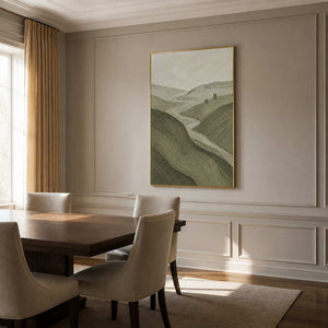 Olive green landscape wall art in a warm dining room with a gold frame.