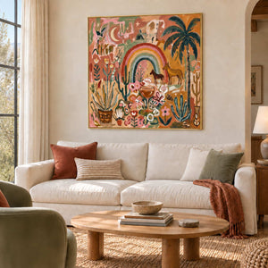Under the Rainbow in a gold frame above a cream sofa with rust and green cushions beside a wood coffee table.