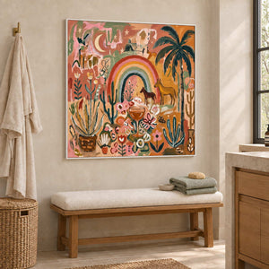 Under the Rainbow in a white frame above a cream cushioned bench with green towels beside a bathroom vanity.