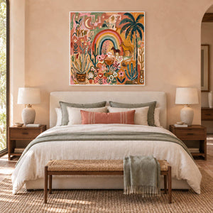 Under the Rainbow in a white frame above a cream bed with sage and coral textiles against a peach wall.