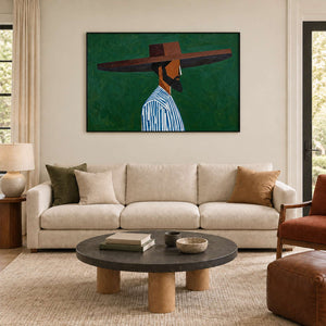 Wide-hat profile portrait above a cream sofa and a dark round coffee table.