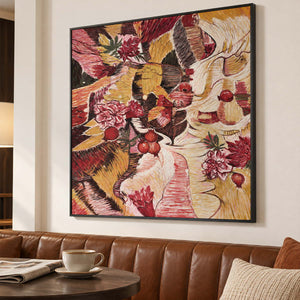 In a seating area, an artwork with a black frame shows red flowers and rounded fruit forms woven through ochre, cream and dark bands.
