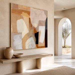 Warm abstract painting above a narrow console beside a sunlit archway.