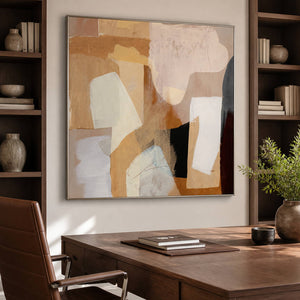 Cream-and-ochre abstract art above a desk between dark built-in shelves.