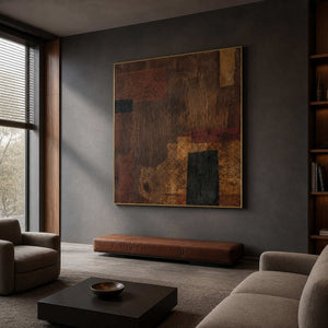 Gold framed brown abstract painting above a leather bench in a boutique hotel lobby.