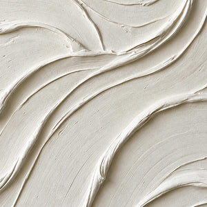 Close-up of broad ivory folds and narrow shadows at their edges.