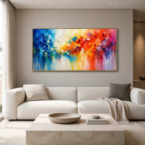 Panoramic blue and orange textured abstract wall art above a bright neutral sofa.