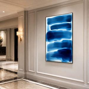 Vertical blue and white abstract wall art along an elegant hallway.
